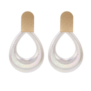 White Teardrop with Gold Tone Crest-Shaped Drop Earrings