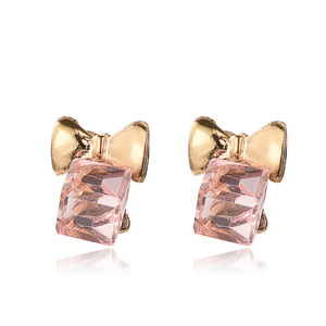 Pink glass cube with gold-tone bow stud earrings