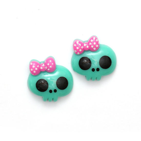 Green baby doll skull with bow clip-on earrings