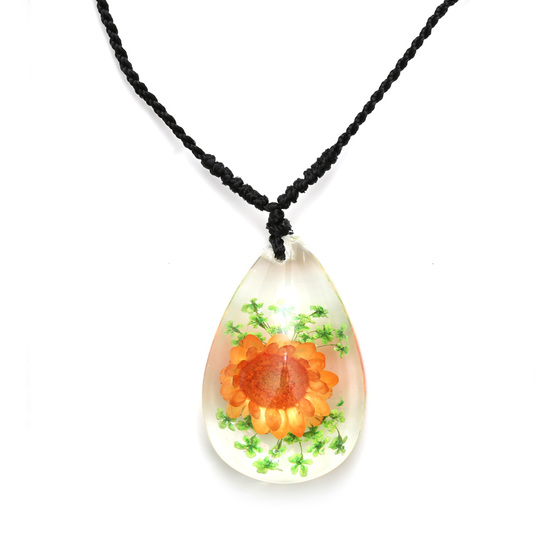 Orange pressed flower in clear resin teardrop...